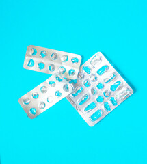 empty used blisters from pills on a blue background