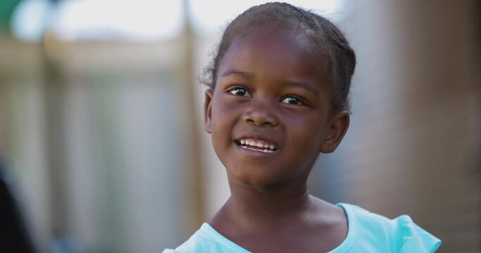 Close-up cute smiling shy portrait Black African township girl