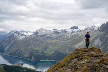 Fototapeta na wymiar Hikers on the hiking trail with backpack mountain lake as background beautiful view