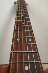 Brown acoustic guitar and strings close-up.