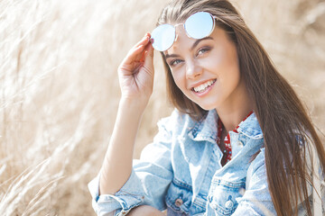 Closeup portrait of young beautiful woman outdoors. Attractive female on neutral background.