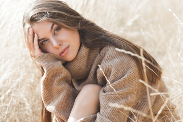 Attractive female. Young woman outdoor. Lady on neutral natural background. Cheerful girl.