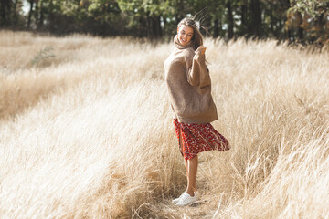 Attractive female. Young woman outdoor. Lady on neutral natural background. Cheerful girl.