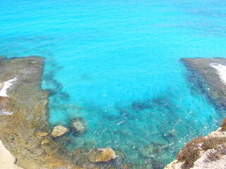 OLYMPUS DIGITSea shore with rocks and turquoise waterAL CAMERA