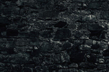 Old grungy retro dirty faded eerie wall of ancient city. Uneven pitted peeled fissured surface of cary cellar. Ruined shabby scary block. Hard foul messy ragged bumps on stonewall for 3D grunge design