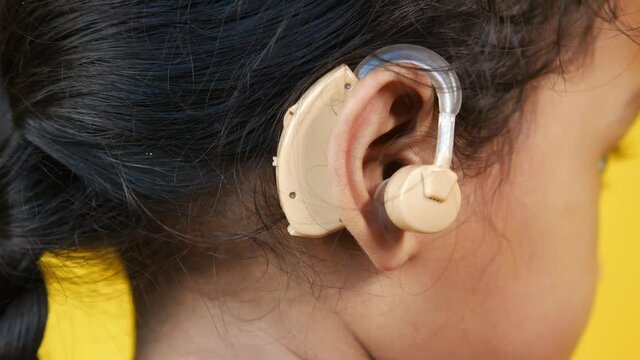Hearing aid concept, a kid with hearing problems.