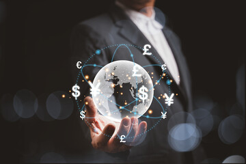 A hologram of a globe in hands of a businessman. And there are virtual lines of currency flows such as yen, yuan, dollars, pounds, euros, revolving around the world. global currency exchange concept