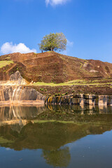 Sri Lanka. Sigiriya Dambulla. The most famous attraction - Lion Rock. View of the pyramid-shaped palace and the pool at the top of the mountain.