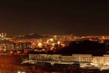 Fototapeta premium Fireworks in the city at night during New Year celebration. Soft focus background
