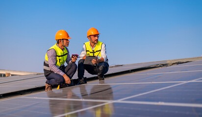 Engineer wearing unifrom and helmet inspect and check solar cell panel ,solar cell is ecology...
