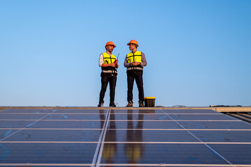Engineer wearing unifrom and helmet inspect and check solar cell panel ,solar cell is ecology...