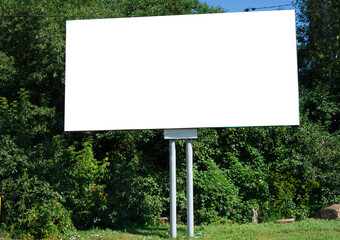 Billboard on the background of green trees
