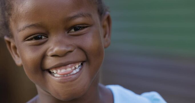 Close-up cute smiling shy portrait Black African township girl