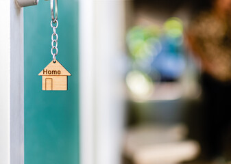 House key with house keyring in the keyhole on the glass door. The concept for purchasing real...