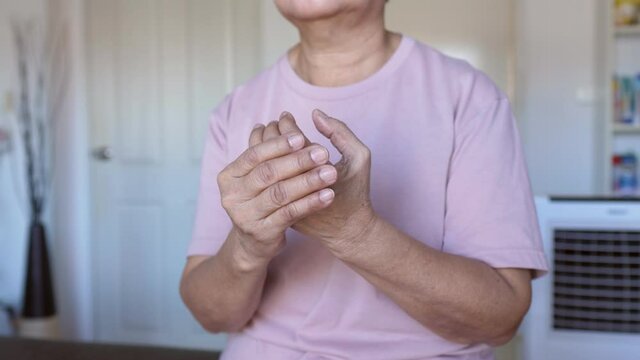 Senior woman massaging hand suffering from beriberi,Disease causing inflammation of the nerves
