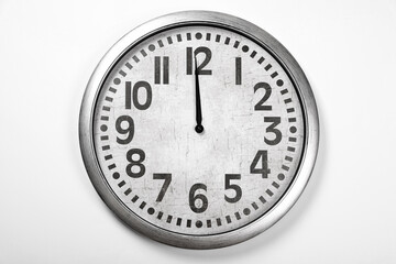 Stylish analog clock hanging on white wall