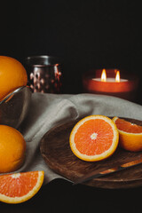 Moody Citrus Flat Lay with Copy Space. Close Up Cara Cara Oranges on Dark Background. Orange Slices...