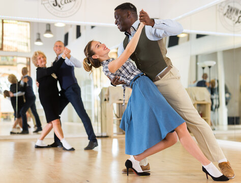 Two professional dancers practicing lindy hop in dance class