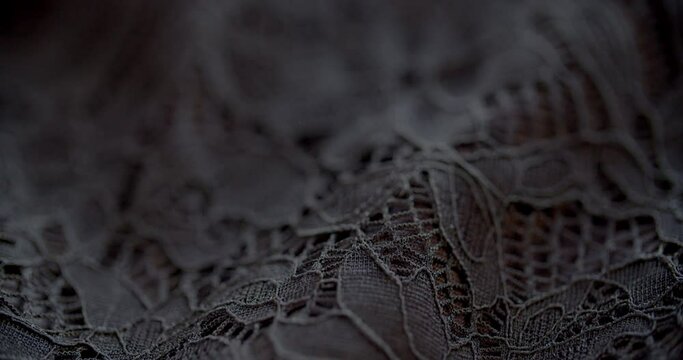 Grey Rumpled Lace Material Against Black Background