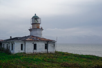 Fototapeta na wymiar Lighthouse Jonquiere and the coast at sunset
