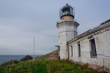 Fototapeta na wymiar Lighthouse Jonquiere and the coast at sunset