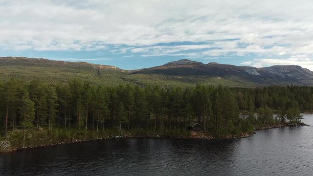 Nedre Bjorvatn Lake Cabin Norway Fly Over Scenic Mountain Range 4k Drone Forestline