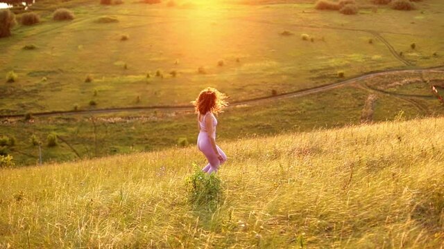 Young woman exercising outdoors against the backdrop of a beautiful sunset, soft focus