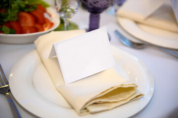Portioned plates in the restaurant for guests with a badge. Background for the signature of the guests at the reception.