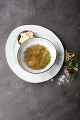 Bowl of pasta soup served with croutons and herbs