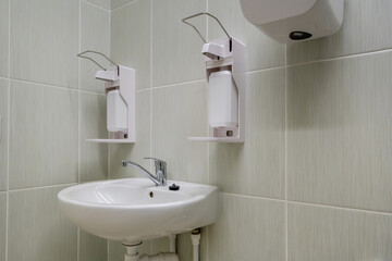 elbow soap and antiseptic dispenser or sanitizer wall mounted for hand disinfection and water tap sink with faucet bathroom or clinic