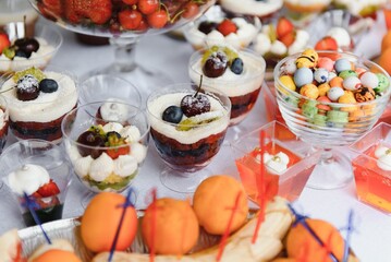 various dessert with fresh fruit on buffet line, sweet