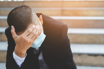 Businessman sitting stressed. Business bankrupt from Covid-19.