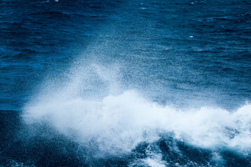 Naklejka premium Ocean water background with foam. Ocean water splash. Not a calm 