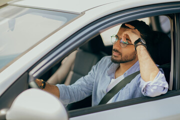 Naklejka premium Arab guy driving nice car, dreaming while stuck in traffic