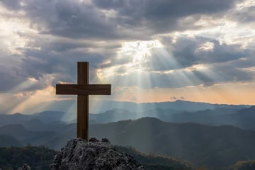 Foto op Plexiglas Silhouettes of crucifix symbol on top mountain with bright sunbeam on the colorful sky background © AungMyo