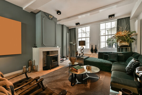 Spacious living room with green sofa and armchairs