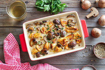 Baked chicken and mushrooms in a creamy sauce. French cuisine. Fricassee.