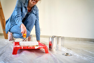Caucasian woman painting wall in new house
