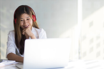 Happy smiling woman working and studying online from laptop.