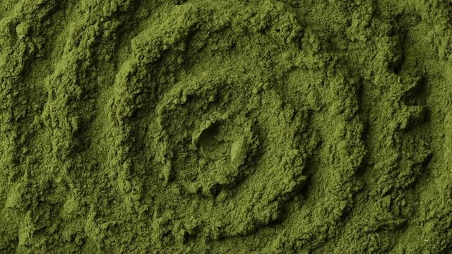 Superfoods moringa, chlorella or spirulina powder rotating. Green super food. Camera moves away from the object. 4K UHD video