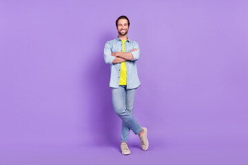 Fototapeta na wymiar Full size photo of smiling handsome businessman with folded arms wear denim style isolated on purple color background