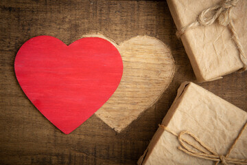 Valentine's Day greetings concept. Gift boxes and Heart shape carved on the wood. Valentines greeting card. Free space for your text