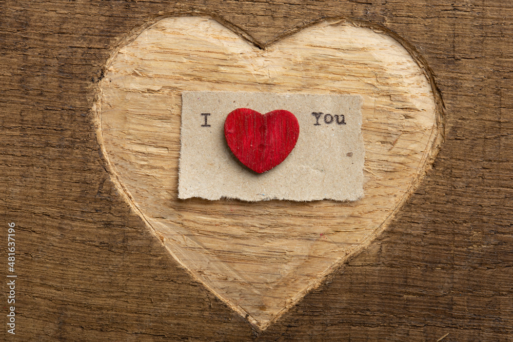 Fototapete i love you - tiny typed text note close up. valentines day greetings concept. carved heart shape on 