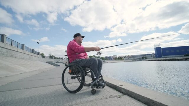 Person with a physical disability who uses wheelchair fishing from pier
