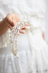 bride hands hold wedding hair accesory. jewelry for bride. headpiece for bride. tiara