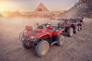 Quad bikes ATV safari in desert background Pyramids Sphinx Cairo, Egypt © Parilov