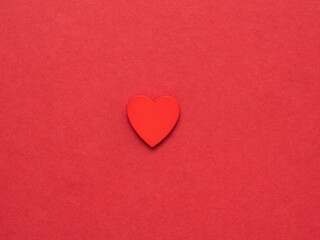 Obraz premium Red heart on the middle of red background. Love background. 