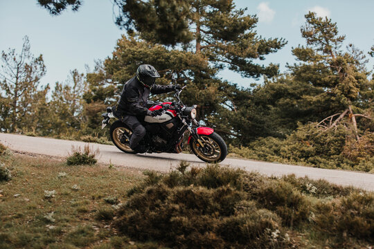 Calar Alto, Spain - May 5th 2021: Man riding a Yamaha XSR700 motorcycle between pine trees, during Dunlop Xperience event in Almería, Spain.