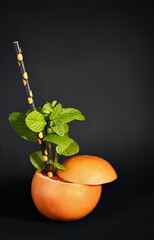 Grapefruit cocktail on black background