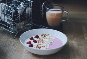 Yogurt breakfast with muesli and a cappuccino 